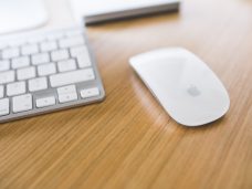 white-apple-mouse-and-keyboard-on-a-wooden-desk-6416